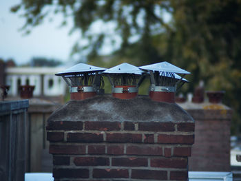 Close-up of cross on roof against building