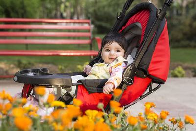 Portrait of cute boy sitting outdoors