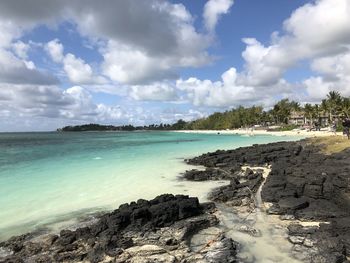 Panoramic view of beach against cloudy sky