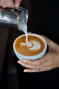 Cropped hand holding coffee