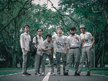 Portrait of friends standing against plants