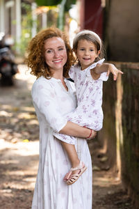 Portrait of young woman standing outdoors