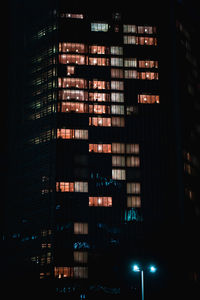 Low angle view of illuminated buildings in city at night