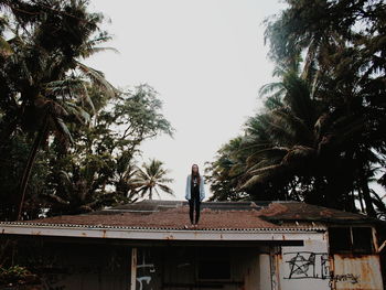 Woman sitting on a statue of a tree