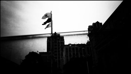 Low angle view of silhouette buildings against clear sky