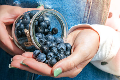 Woman holding bowl with fresh blueberries. harvesting concept. female hands collecting berries. 