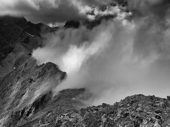 Scenic view of mountains against cloudy sky