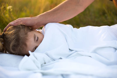 High angle view of woman lying on bed