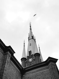 Low angle view of birds flying against sky