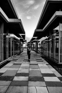 Man walking on railroad station platform in city