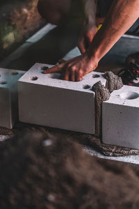 Close-up of man working on grill