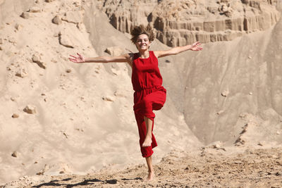 Full length portrait of a smiling young woman