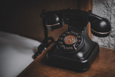 Close-up of vintage telephone on table