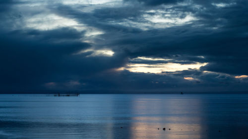 Scenic view of sea against cloudy sky