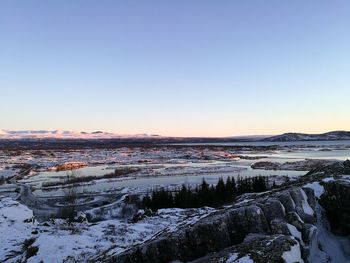 Scenic view of frozen lake against clear sky