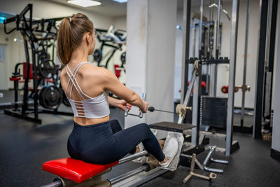 Young woman exercising in gym