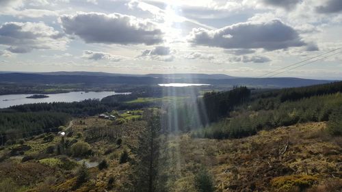 Scenic view of landscape against cloudy sky