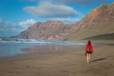 Woman on beach against sky