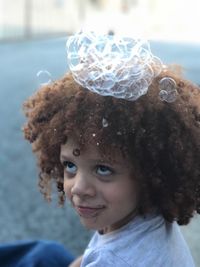 Close-up of boy with bubbles on hair