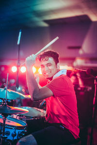 Portrait of young man sitting at music concert