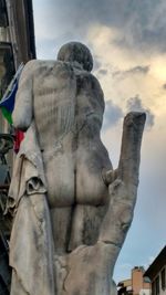 Low angle view of statue against cloudy sky