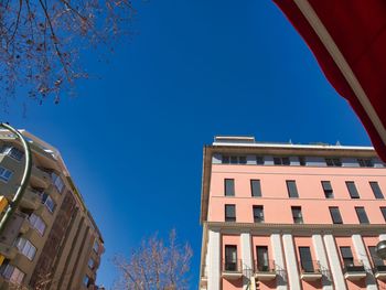 Low angle view of building against clear blue sky