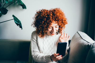 Smiling woman on video call at home