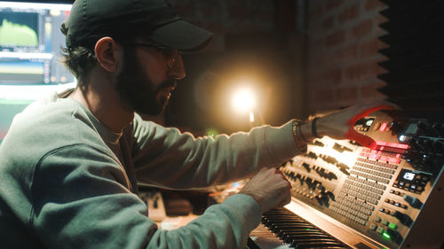 Side view of man working in studio