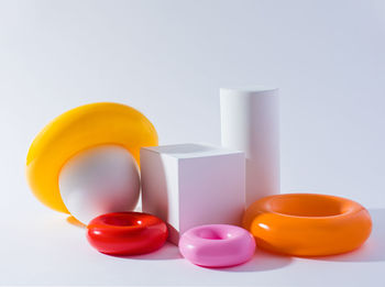 Close-up of drink in container on table against white background