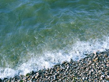 High angle view of waves reaching on shore