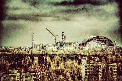 Traditional windmill against sky with buildings in background