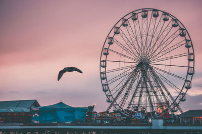 Low angle view of ferris wheel against sky