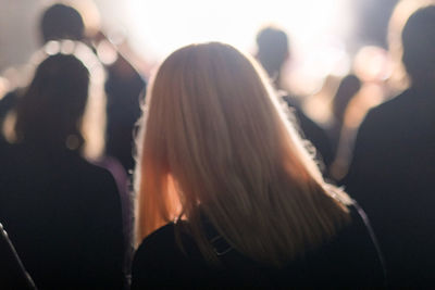 Rear view of people enjoying at music concert