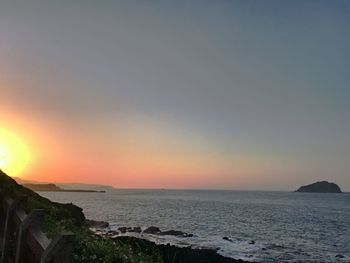 Scenic view of sea against clear sky during sunset