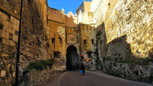 Person walking amidst buildings