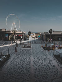 People walking on street against sky