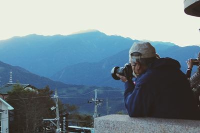 Man photographing on mountain