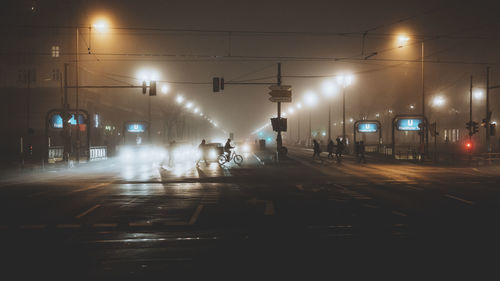 People in illuminated city at night