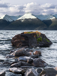 Scenic view of sea and mountains against sky