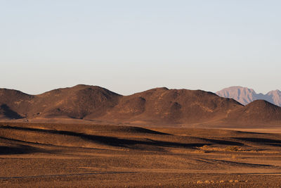 Scenic view of desert against clear sky