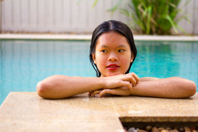 Portrait of asian woman standing on the edge of pool