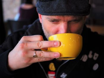 Close-up of man drinking coffee