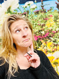 Portrait of beautiful woman with red flower