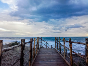 Pier over sea against sky