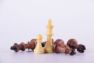 Close-up of chess pieces against white background