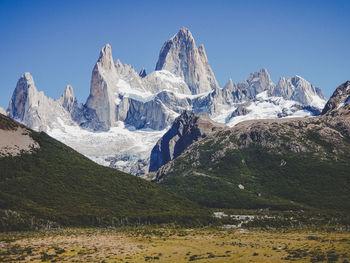 Scenic view of snowcapped mountains against clear sky