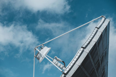 Low angle view of crane against sky