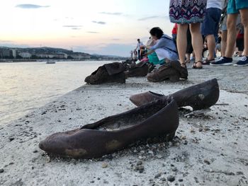 People at beach against sky