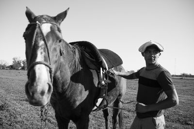 Portrait of young man and his horse