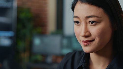 Close-up of young woman looking away